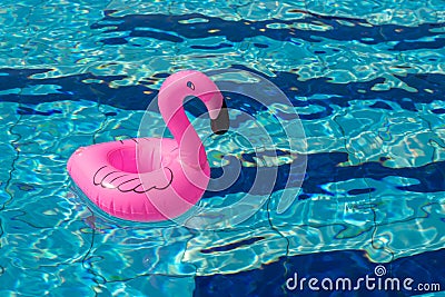 Summer concept background. Pink inflatable flamingo in pool water for summer beach background. Pool float party Stock Photo