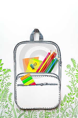 Summer concept, school backpack on green grass, made of paper Stock Photo