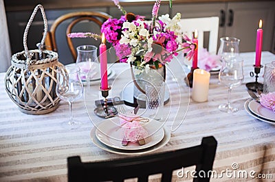 summer cottage kitchen decorated for festive dinner. Romantic table setting with candles Stock Photo