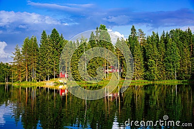 Summer cottage or log cabin by the blue lake in rural Finland. Stock Photo