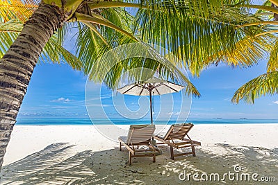 Summer couple destination scenic beach beds chairs umbrella palms. Love romantic travel landscape Stock Photo