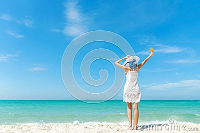Summer Day. Lifestyle woman wearing white dress fashion summer beach on the sandy ocean beach. Happy woman enjoy and relax vacat Stock Photo