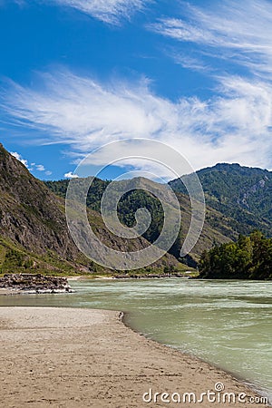 Summer day in mountainous Altai on the banks of the Katun river with turquoise water and mountain ranges covered with green forest Stock Photo