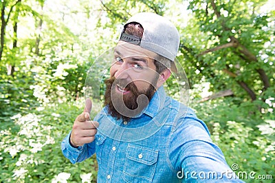 summer day rest in nature. hiking in forest. concept of hiker lifestyle. cheerful man making selfie. Stock Photo