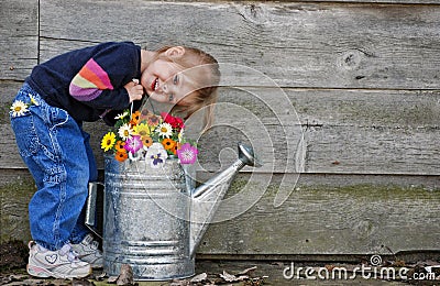 little girl with watering can Stock Photo