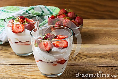 Summer dessert with whipped cream and strawberry on wooden background Stock Photo