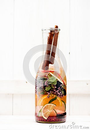 Summer detox and refreshing drink lemonade with fresh fruits, berries and herbs in glass bottle Stock Photo