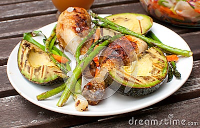 Summer dinner outside with grilled chicken and vegetables Stock Photo