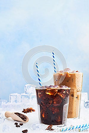 Summer drink iced coffee in a glass and ice coffee with cream in a tall glass surrounded by ice cubes Stock Photo