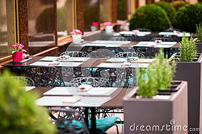 Summer empty open air restaraunt in italian city in Europe. Closeup wineglasses on the table Stock Photo