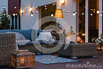 Evening on the patio of beautiful suburban house with lights in the garden garden Stock Photo