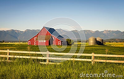 Summer evening with a red barn in rural Montana Stock Photo