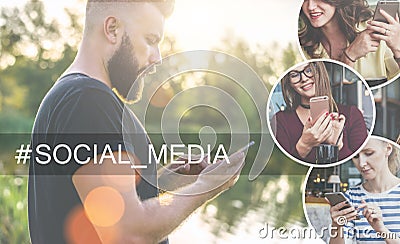 Summer evening.Sunset.Side view.Backlight.Young bearded man in black t-shirt standing in park and using smartphone. Stock Photo