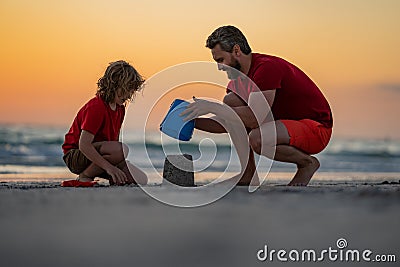 Summer family. Kid and father building sandcastle. Father and son playing on summer beach. Father and child son playing Stock Photo