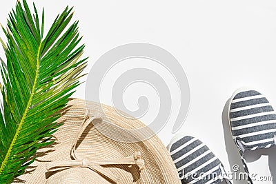 Summer fashion tropical concept. Women`s female beachwear straw hat canvas striped shoes coconut green palm leaf on white Stock Photo