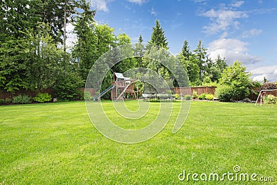 Summer fenced backyard with play area. Stock Photo