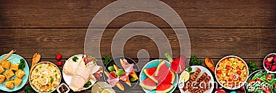 Summer food bottom border over a dark wood banner background Stock Photo