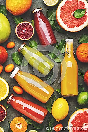 Summer fruit drinks. Citrus juices and smoothies in bottles, food background, top view. Mix of different whole and cut fruits: Stock Photo