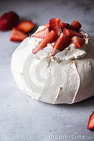 Summer fruit pavlova - famous Australian dessert from baked whipped egg whites and cream cheese filling with strawberries Stock Photo