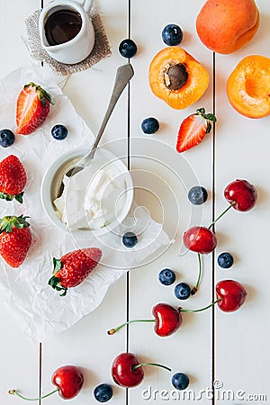 Summer fruits. Fresh juicy berries and apricot on the white wooden table, top view Stock Photo