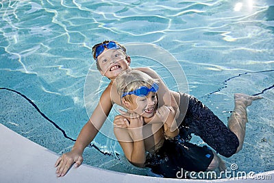 Summer fun, boys playing in swimming pool Stock Photo