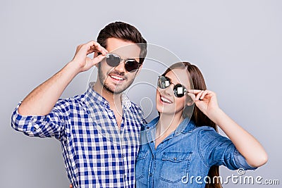 Summer and fun mood. Young students are wearing trendy sunglasses and smile, in casual shirts, posing on the pure background. Pret Stock Photo