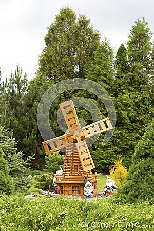 Summer garden with a decorative windmill and gnomes Stock Photo