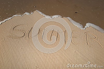 summer handwritten on sand, summer background, sea and sand background Stock Photo