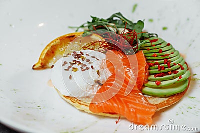 Summer healthy fastfood lunch, breakfast with Pancake with red fish, avocado and egg for breakfast. Aesthetic still life Stock Photo