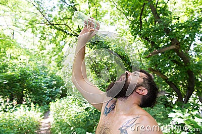 Summer heat. Man thirsty sweaty hipster naked in forest. Heat concept. Bearded tattooed guy relax in nature hot summer Stock Photo