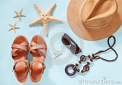 Summer holiday background, flat lay beach women`s accessories: straw hat, bracelets, leather sandals, sun glasses, beads Stock Photo