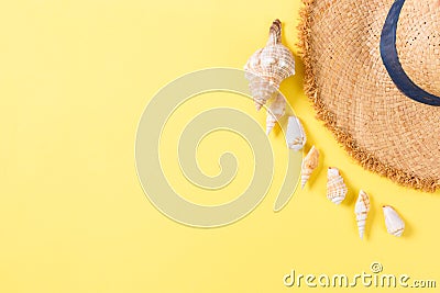 Summer holiday background with straw hat and seashells on yellow background top view with copy space Stock Photo