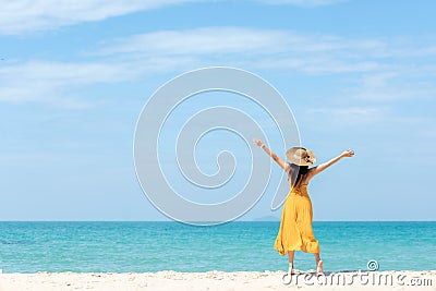 Summer Holiday. Lifestyle woman chill holding big white hat and wearing yellow dress fashion summer trips standing chill on the sa Stock Photo