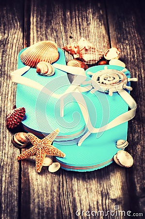 Summer holiday setting with flip flops and sea shells Stock Photo