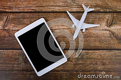 Summer holiday on wooden table background travel concept with using digital tablet on airplane model plane Stock Photo