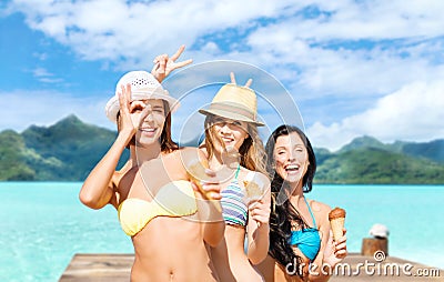 Young women in bikini with ice cream on beach Stock Photo