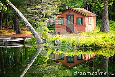 Summer home cabin in the woods at the lake Stock Photo