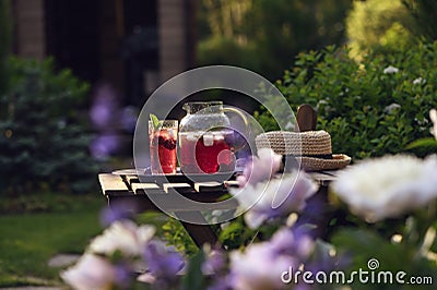summer homemade cherry lemonade with ice in blooming garden Stock Photo