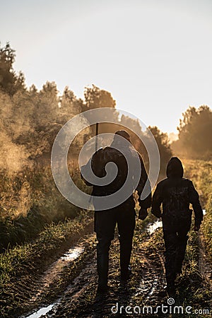 Summer hunting at sunrise. Hunter moving With Shotgun and Looking For Prey. Stock Photo