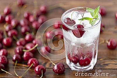 Summer iced drink - cherry with ice. On rustic wooden table Stock Photo