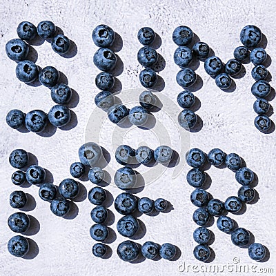 Summer inscription lined from blueberries. Fruits and berries, vegetarian and healthy eating concept. Summer text Stock Photo