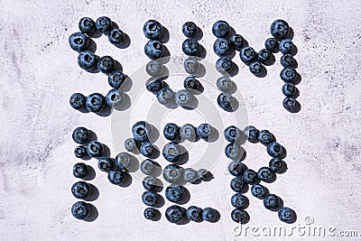 Summer inscription lined from blueberries. Fruits and berries, vegetarian and healthy eating concept. Summer text Stock Photo