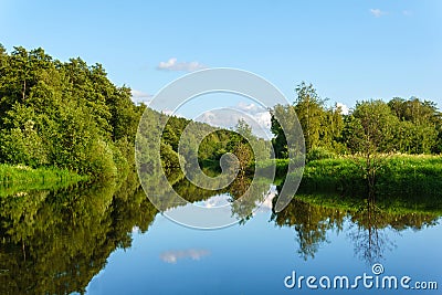 Summer landscape of a calm oxbow lake with wooded shores Stock Photo