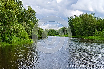 Summer landscape of a calm oxbow lake with wooded shores Stock Photo