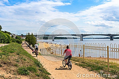 Russia Kostroma July 2020. Cyclists on the walking path along the Volga River. Editorial Stock Photo