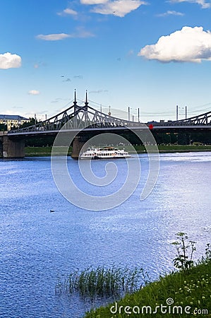 Summer view of the Volga river and cruise pleasure boat and the old Volga bridge, city of Tver, Russia. Stock Photo