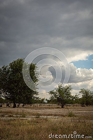 Summer landscape in the field church on the horizon. HDR image. Gloomy landscape Stock Photo