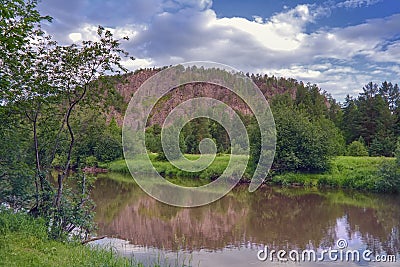 Summer landscape forest river on a background of mountains and blue sky Stock Photo