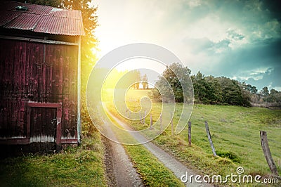 Summer landscape with old barn and country road Stock Photo