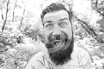 Summer madness. Man cheerful bearded hipster taking selfie in wild nature. Guy crazy emotional face surviving in hot Stock Photo
